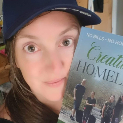 Laura holding Creatively Homeless book